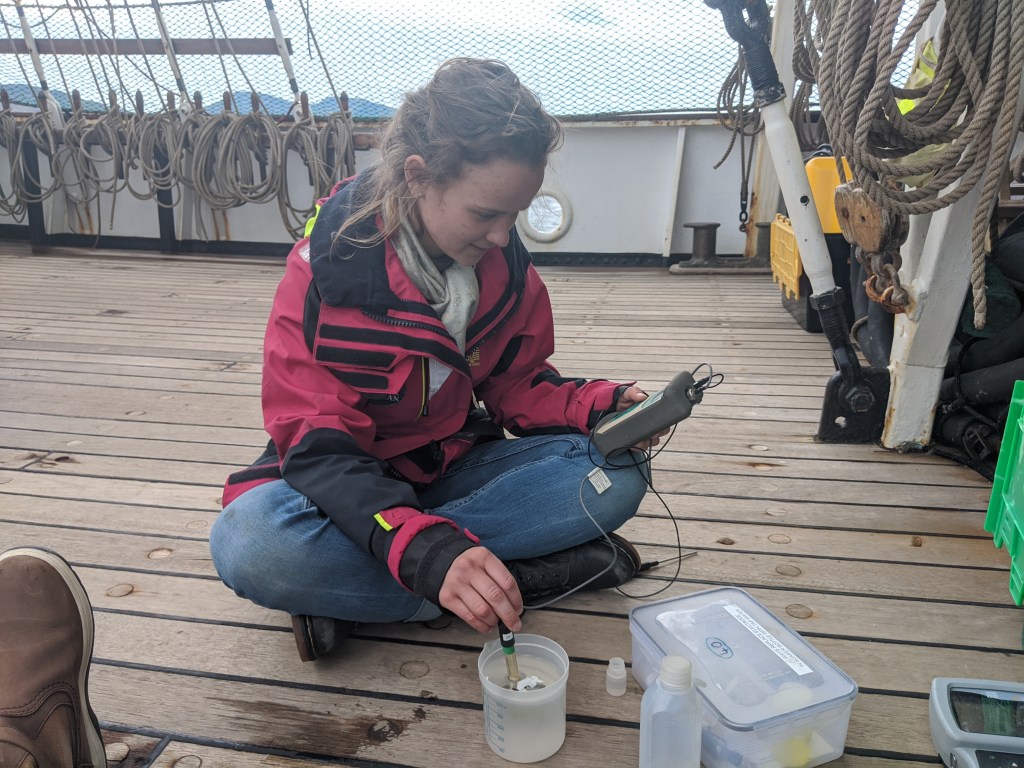 Young scientist calibrating a pH meter aboard the Pelican of London. (c) C Braungardt