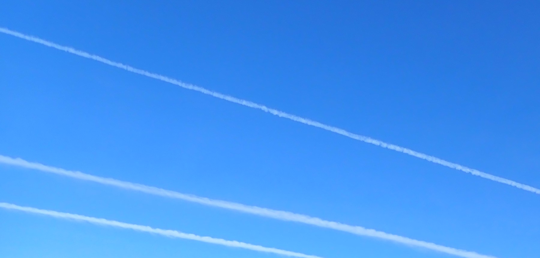 blue sky with aircraft 'vapour' trails