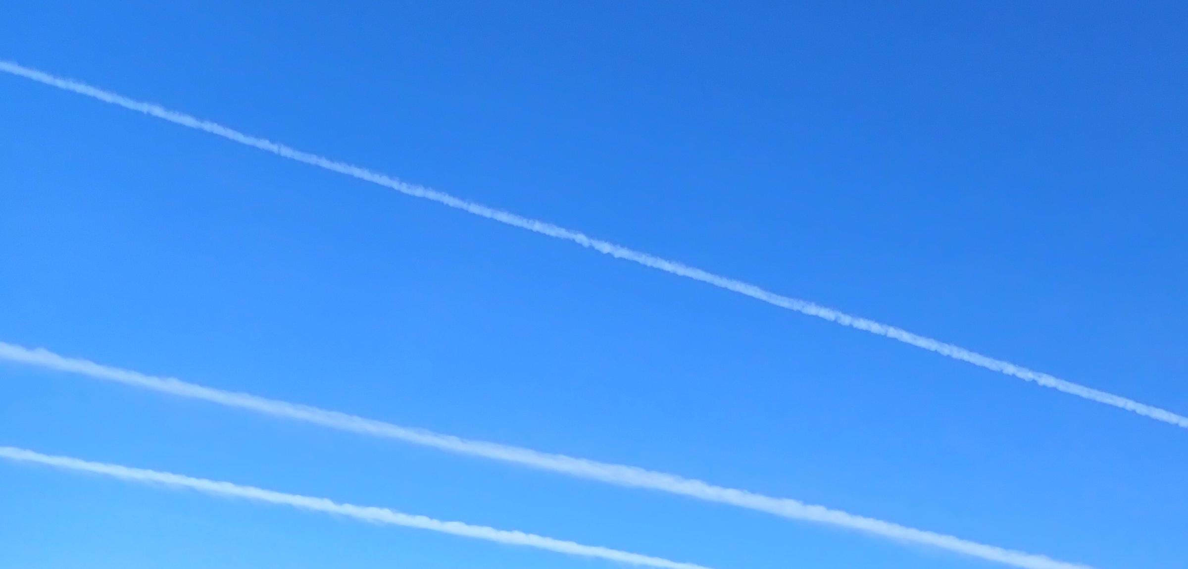 blue sky with aircraft 'vapour' trails